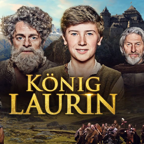 Filmplakat des Märchenfilms König Laurin. Mit den Köpfen des Königsssohns Theo, des Königs und des Zwergenkönigs. Mittig in großer Schrift steht König Laurin.